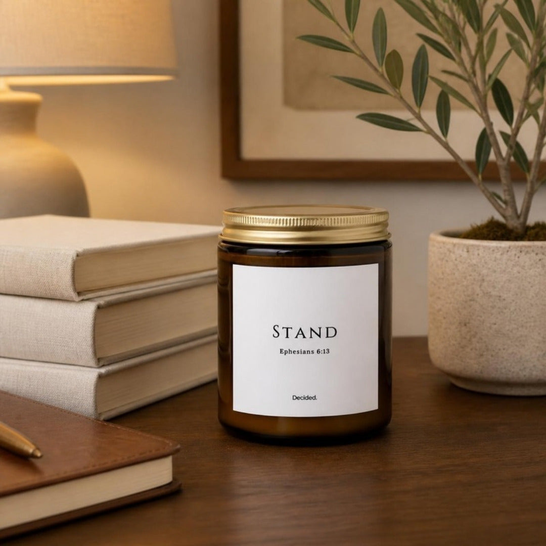 STAND Ephesians 6:13 scripture candle styled in a cozy home setting - DECIDED.